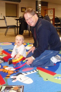 Bob Dickerson playing with a child